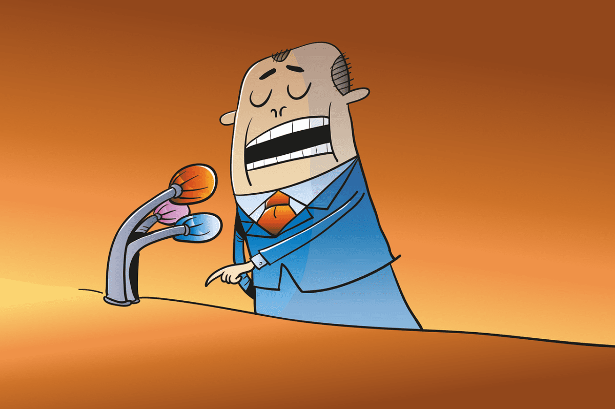 Auf dem Bild sieht man im Comicstil eine Illustration eines Mannes im blauen Anzug, der vor einem Rednerpult gerade eine Rede hält.